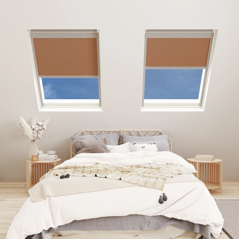 Bedroom with two skylights featuring brown blinds and a neatly made bed.