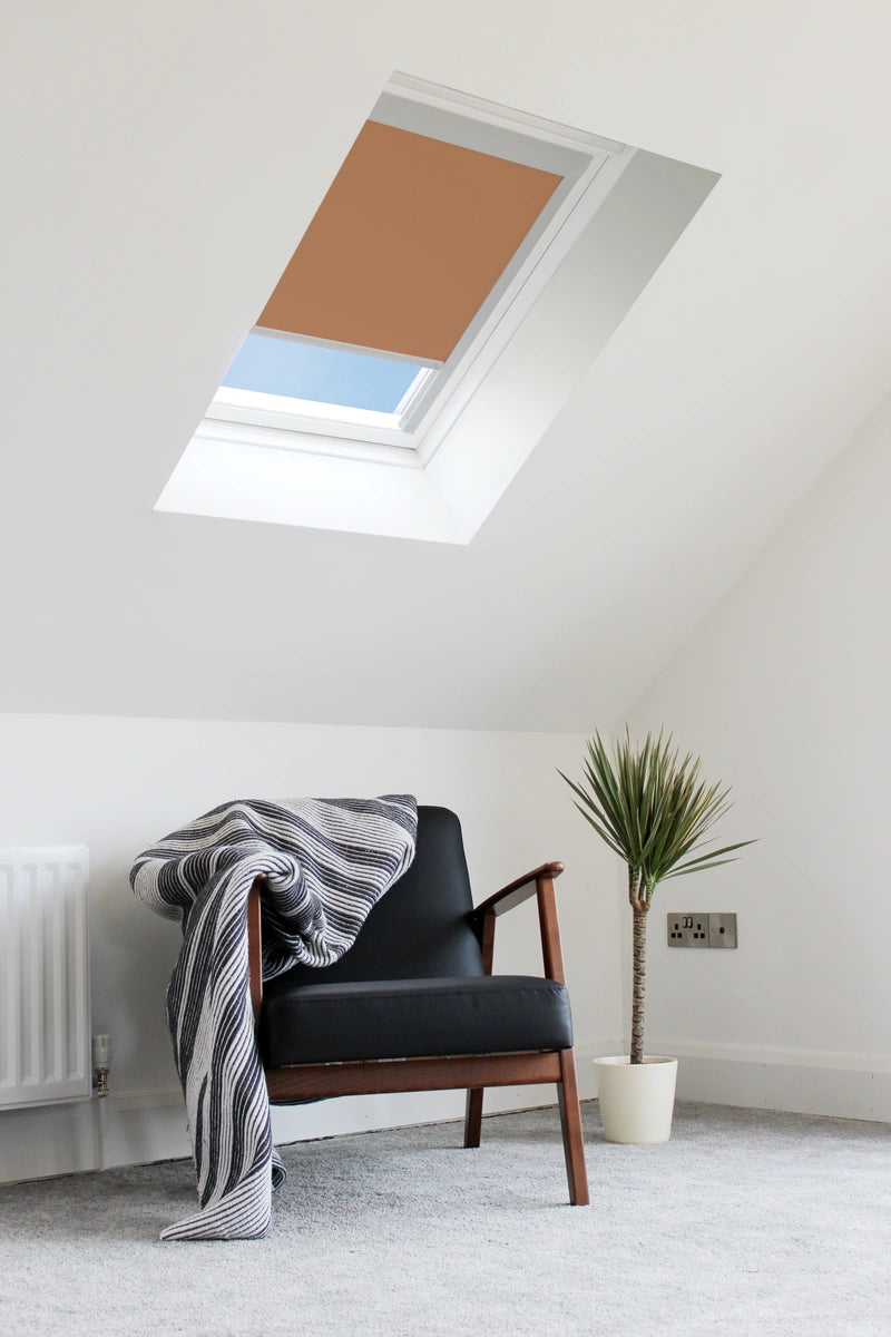 Skylight with brown cover in a room with a chair, plant, and radiator.