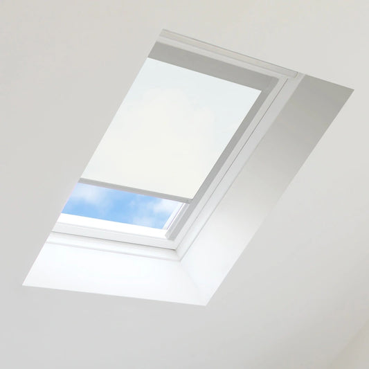 Skylight with a white blind partially open, revealing blue sky.