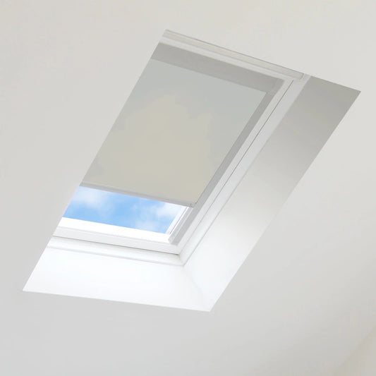 Skylight with a white blind partially open, revealing blue sky.