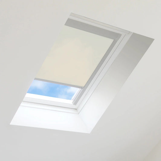 Skylight with a white blind partially open, showing blue sky outside.