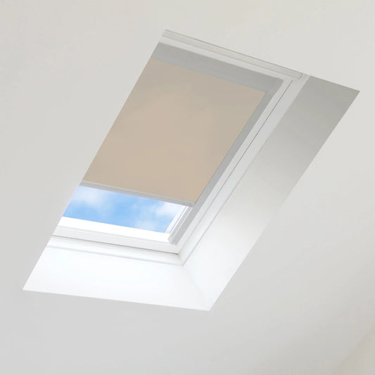 Skylight with a beige blind partially open, showing blue sky outside.