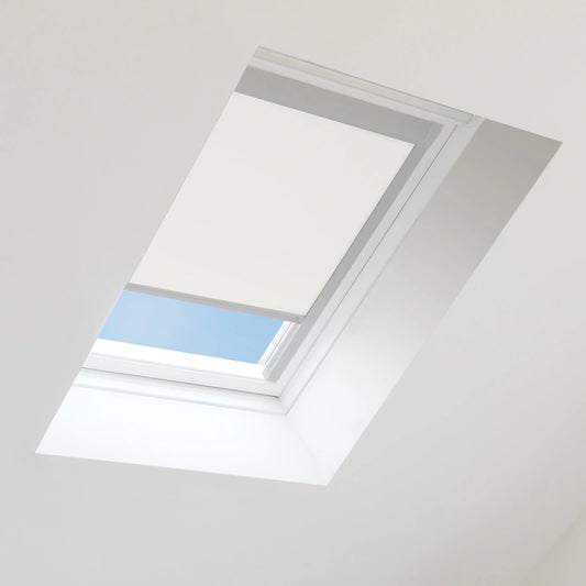 Skylight with a white blind partially open, showing blue sky outside.
