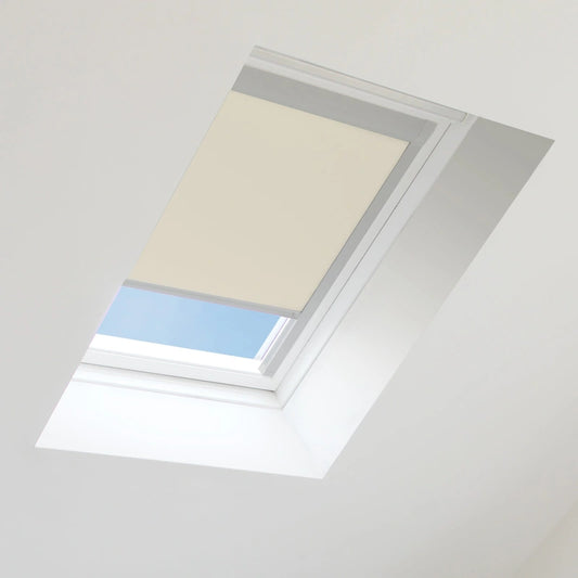 Beige roof window blind partially covering a skylight with blue sky visible