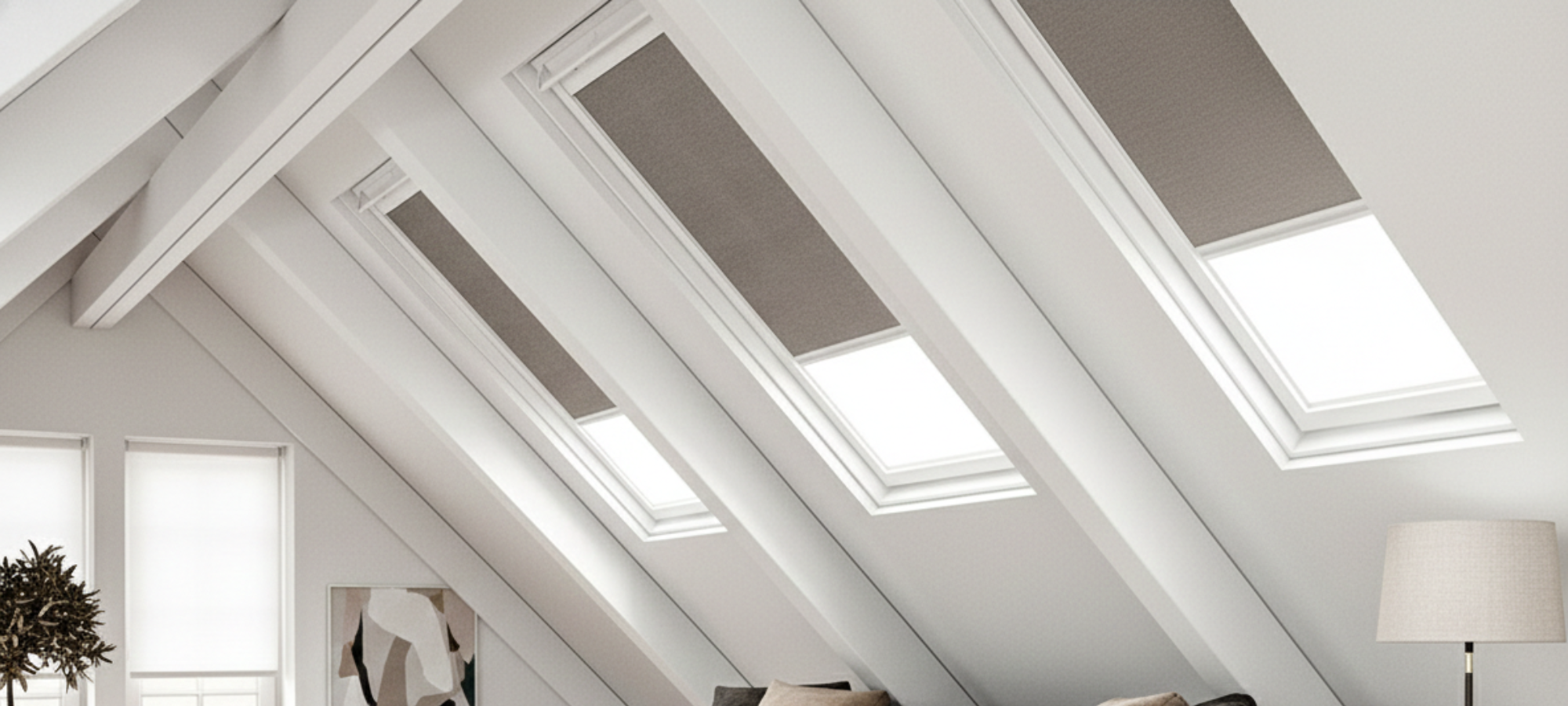 Skylights in a roof with white beams and a lamp in the corner.